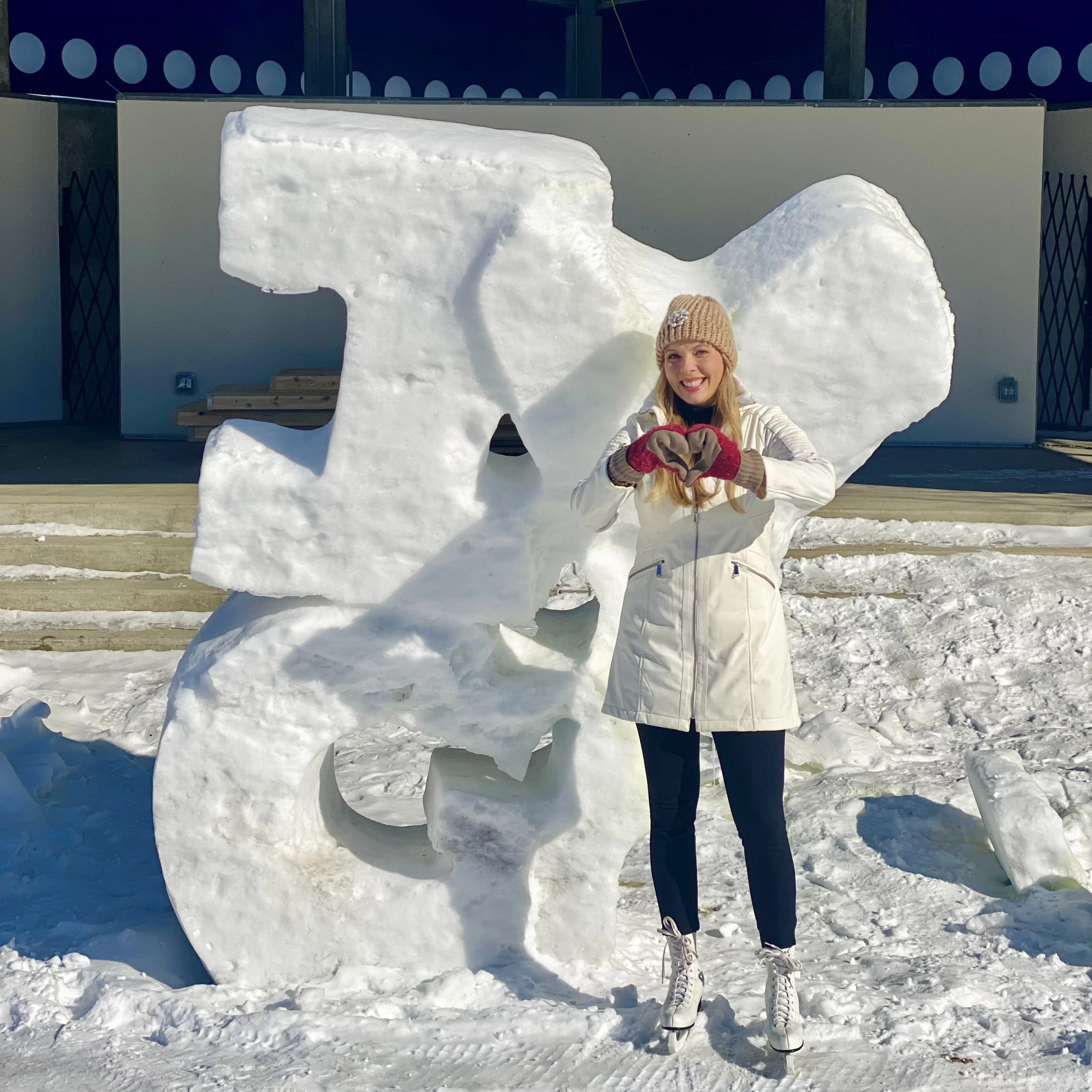 winter-in-grand-forks-skating Winter in Grand Forks Cassandra standing in front of ice sculpture that says, ' I love Grand Forks'