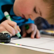 Kid-Drawing-at-Grand-Forks-Public-School Kid drawing with green marker at Grand Forks Public School