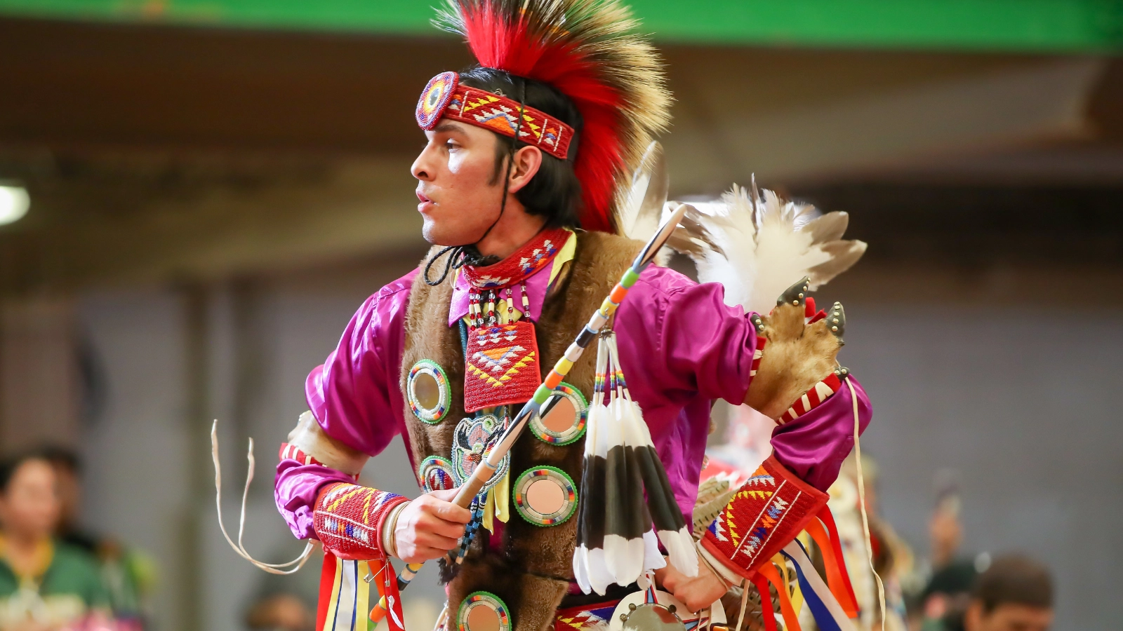 wacipi-powow Man dressed in cultural attire dancing at Wacipi Powow in Grand Forks.