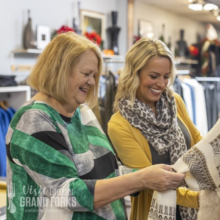 Shopping in Grand Forks Two women browse the clothing rack at RH Standard in Grand Forks