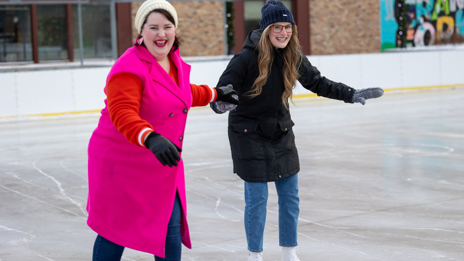Becca and Friend skating downtown Becca and Friend skating at the downtown outdoor rink! they are holding hands and laughing.
