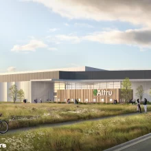 Altru Sports Complex Rendering JLG Renderings of the new altru sports complex being built. It is set in a field surrounded by tall grasses and has tall windows surrounding the exterior.