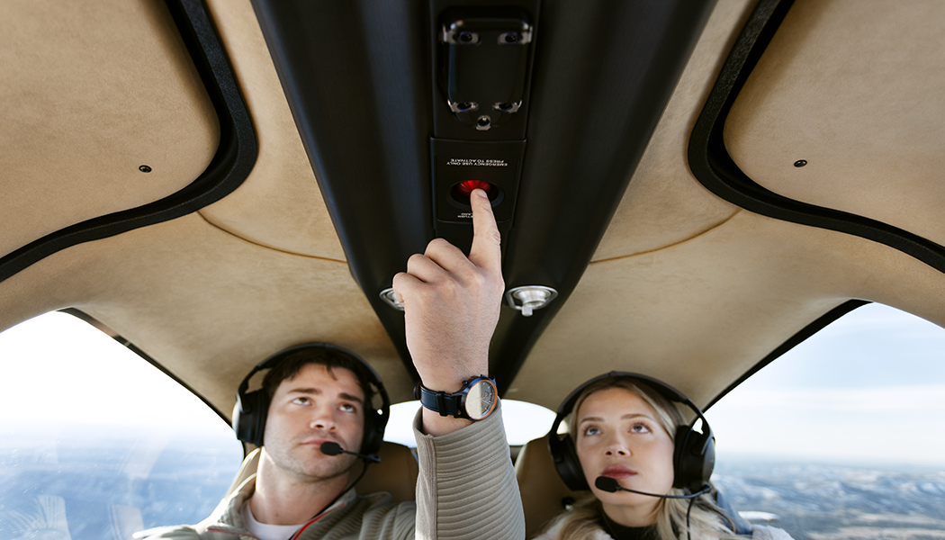 cirrus career photo employees press a button inside the plane while flying