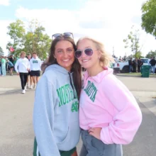 Author Lauren Tailgate Photo Author Lauren in the pink sweatshirt poses with a friend at the UND Tailgate