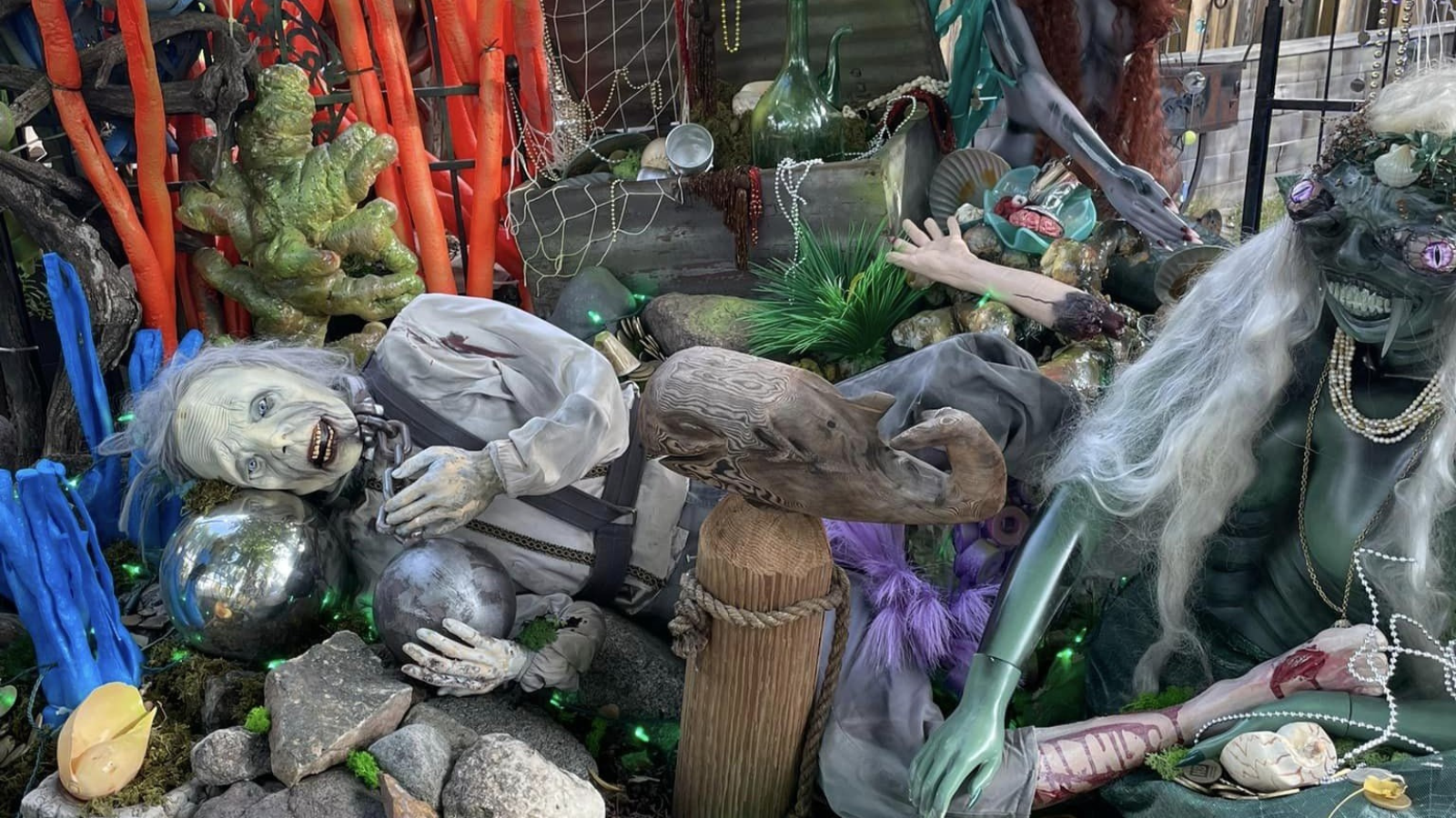 Halloween Decor Halloween decorations depicting mermaids, their victim, a treasure chest, and a seascape.