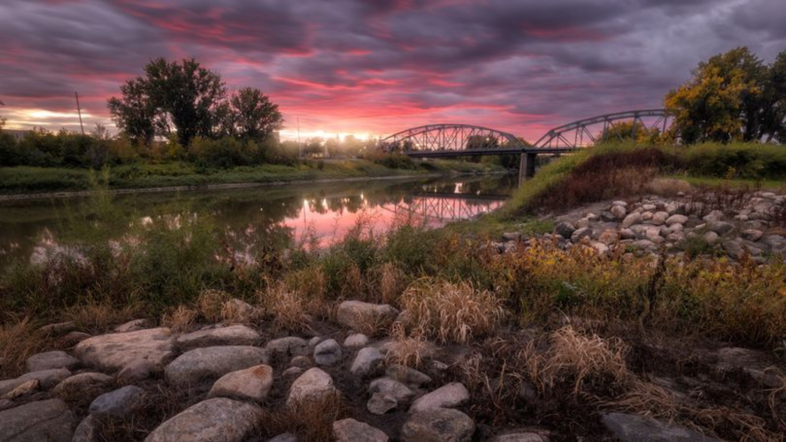 WCT-2026-Green-Precious-Article two-image five Grand Forks river view sunset with the bridge in the background
