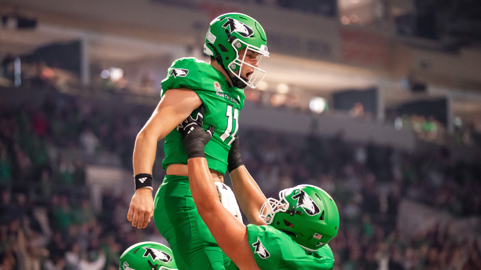 UND Football Celebration UND football team celebrates a touchdown in their green uniforms