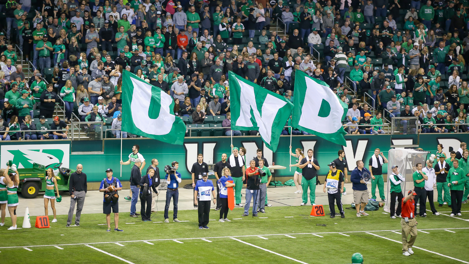 A UND football team has an eager fan base in the stands. The flags are ready.