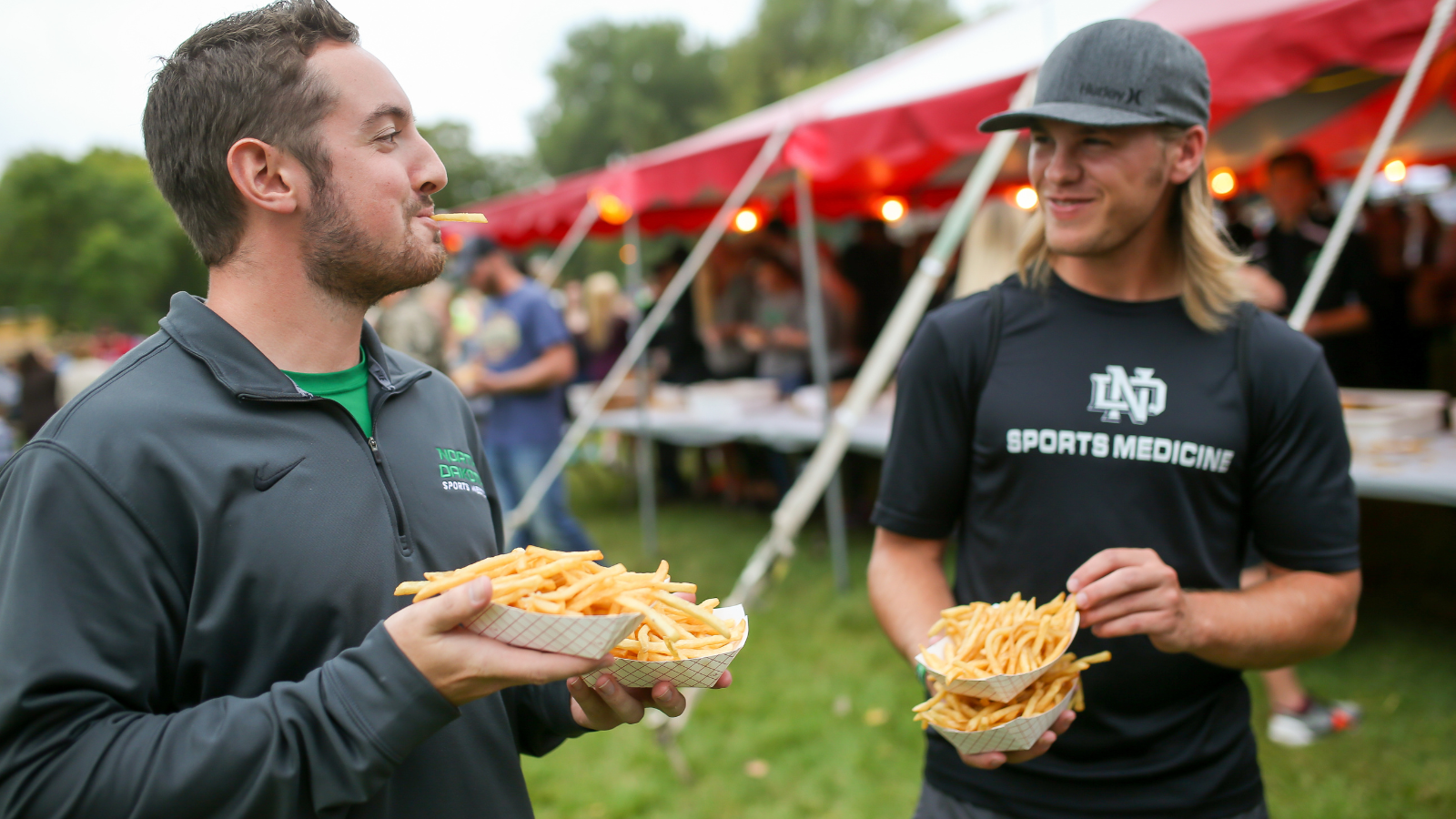 Two men attend the French Fry Feed in University Park